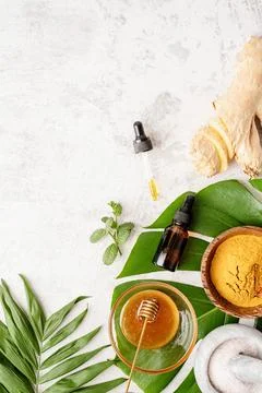 Natural cosmetics ingredients on the table. Tumeric powder, honey, ginger and Stock Photos