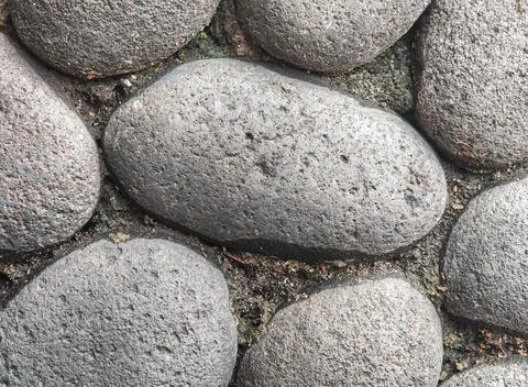 Natural Dark Stone Texture Surface with Rounded Rocks Fotos Stock