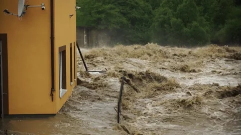 Natural disaster . Fast flowing raging river. Soil and mud is moving towards dow Stock Footage