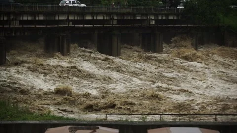 Natural disaster . Fast flowing raging river. Soil and mud is moving towards dow Stock Footage 133635697