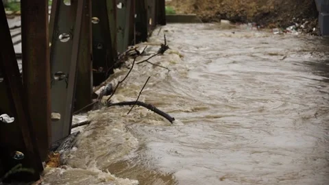 Natural disaster . Fast flowing raging river. Soil and mud is moving towards dow Stock Footage 133636479