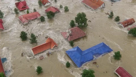 A natural disaster—Flood hits countryside town from the top view. Stock Footage