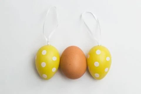 Natural egg and two Easter plastic artificial eggs Stock Photos