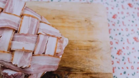 Natural finished dish: arranging bacon strips under stuffed pork Stock Footage 342184812