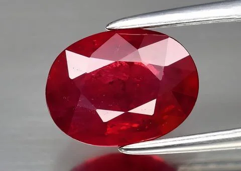 Natural gem red ruby on gray background Stock Photos