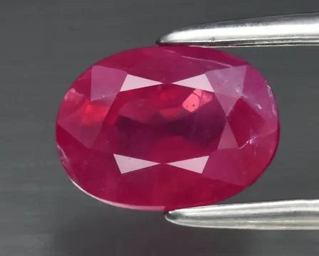 Natural gemstone red ruby on a gray background Stock Photos