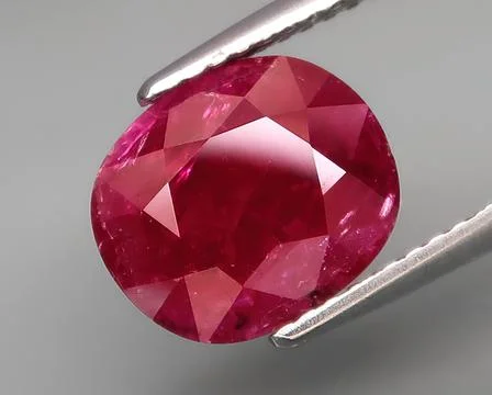 Natural gemstone red ruby on a gray background Stock Photos