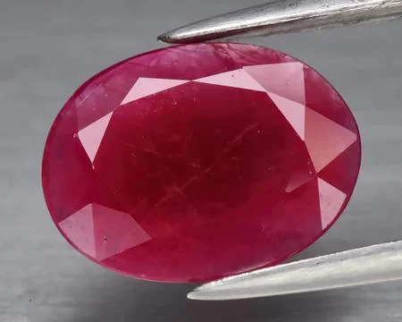 Natural gemstone red ruby on gray background 스톡 사진