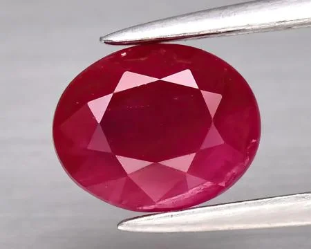 Natural gemstone red ruby on gray background Stock Photos