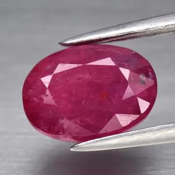 Natural gemstone red ruby on gray background Stock Photos