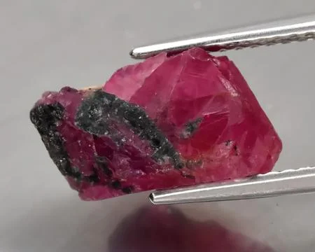 Natural gemstone red ruby on gray background Stock Photos