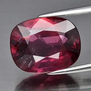 Natural gemstone red ruby on gray background Stock Photos