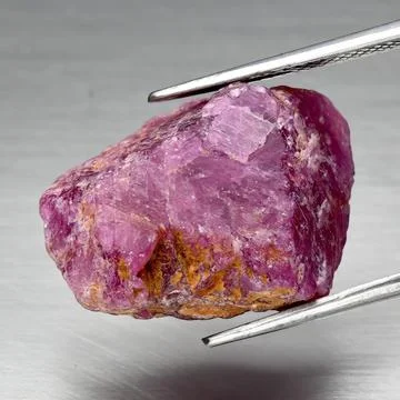 Natural gemstone red ruby on gray background 库存照片
