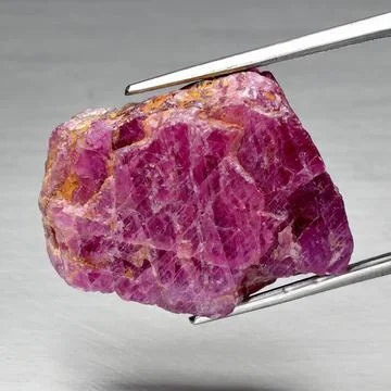 Natural gemstone red ruby on gray background Stock Photos