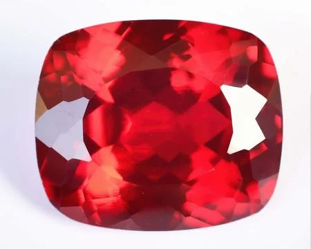 Natural gemstone red ruby on gray background 库存照片