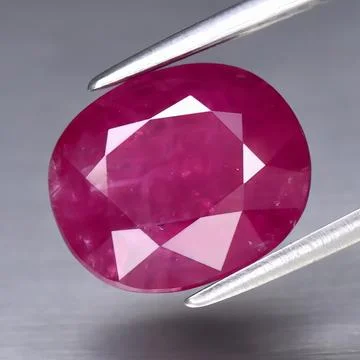 Natural gemstone red ruby on gray background Stock Photos