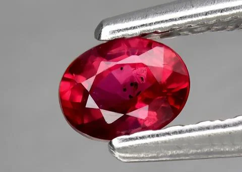 Natural gemstone red ruby on gray background 스톡 사진