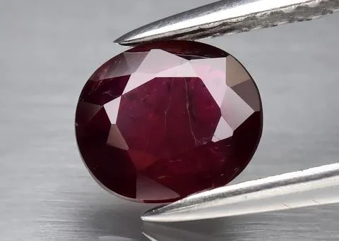 Natural gemstone red ruby on gray background Foto stock