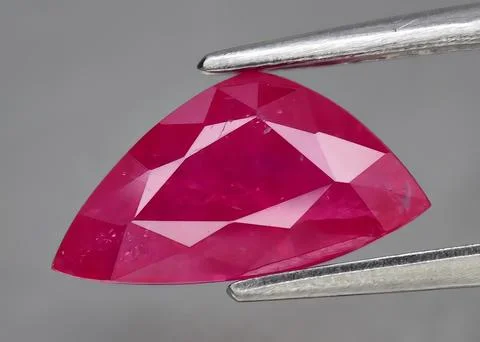 Natural gemstone red ruby on gray background Stock Photos