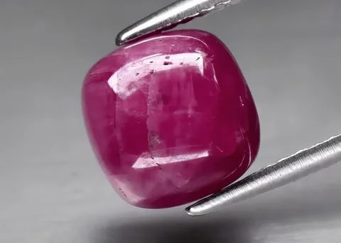 Natural gemstone red ruby on gray background Stock Photos