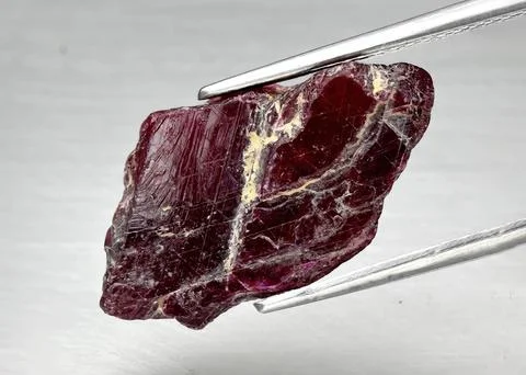 Natural gemstone red ruby on gray background 库存照片