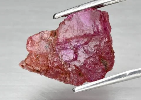 Natural gemstone red ruby on gray background Stock Photos