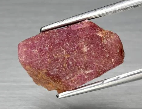 Natural gemstone red ruby on gray background 库存照片