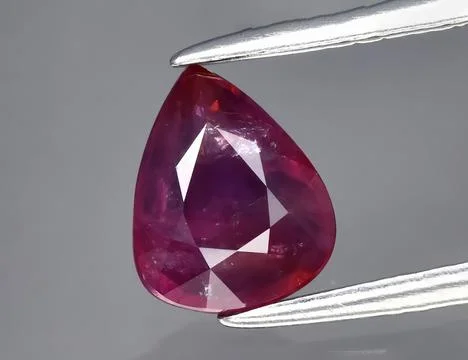 Natural gemstone red ruby on gray background Stock Photos