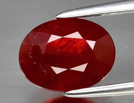 Natural gemstone red ruby on gray background 库存照片