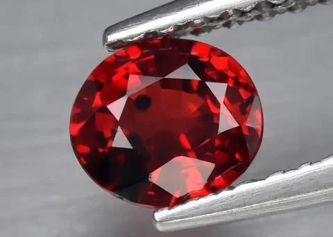 Natural gemstone red ruby on gray background 스톡 사진