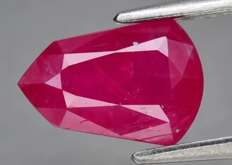 Natural gemstone red ruby on gray background 库存照片