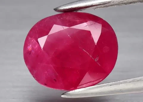 Natural gemstone red ruby on gray background 스톡 사진