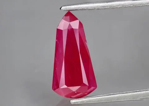 Natural gemstone red ruby on gray background Stock Photos