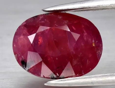 Natural gemstone red ruby on gray background 스톡 사진