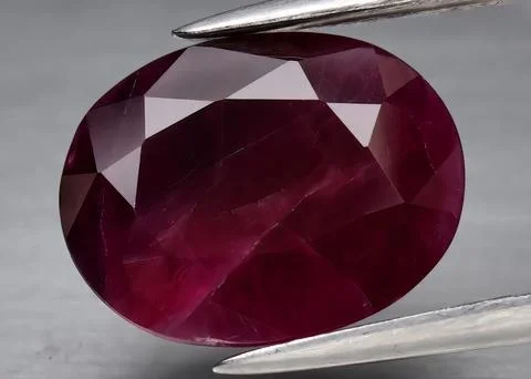 Natural gemstone red ruby on gray background 스톡 사진