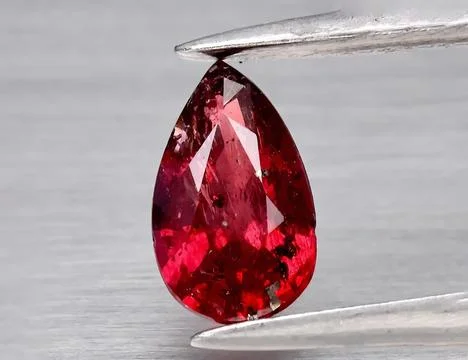 Natural gemstone red ruby on gray background 스톡 사진