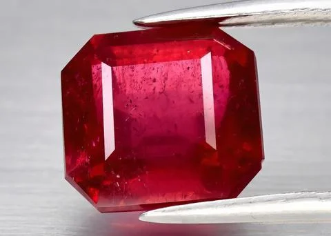 Natural gemstone red ruby on gray background Stock Photos