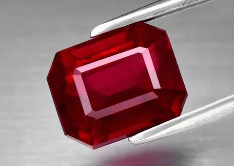 Natural gemstone red ruby on gray background Foto stock