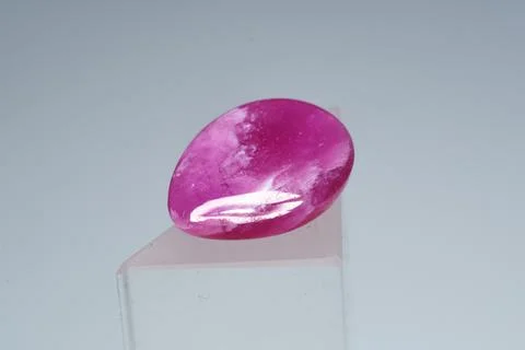 Natural gemstone ruby on a stand white background 库存照片