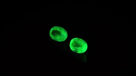 Natural green opal hyalite under uv light on the black background Stock Footage 278548383