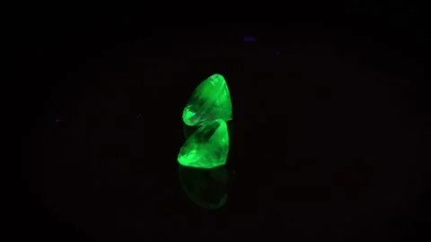 Natural green opal hyalite under uv light on the black background Stock Footage 278548384