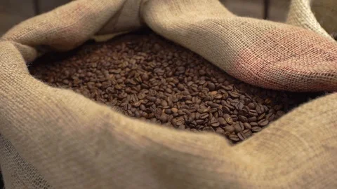 Natural grey big canvas bag with unroasted coffee grains Stock Footage 128268341