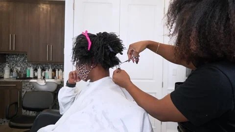 Natural hair model receiving a hair cut Stock Footage
