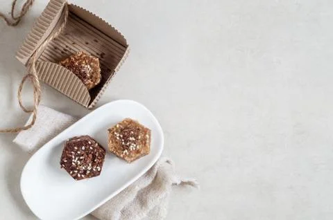 Natural helpful candy from dates, nuts, honey and raisins on a white plate Stock Photos
