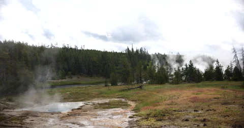 Natural hot spring surrounded by mountains and wilderness Stock Footage 341435673