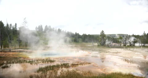 Natural hot spring surrounded by mountains and wilderness Stock Footage 341436018