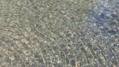 Natural hot spring water pouring into spring pool Stock Footage 148563345