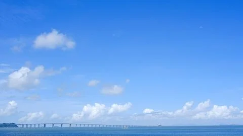 Natural landscape background, bridge,  white clouds, ocean and coastline Stock Photos
