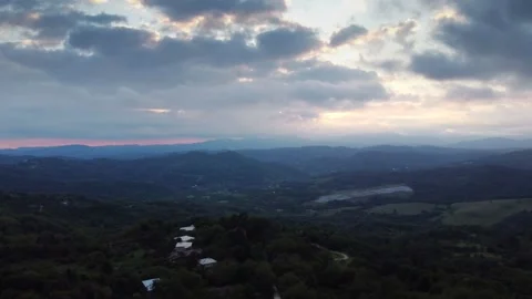 Natural landscape with cloudy sky, mountains, and water creating a scenic valley Stock Footage 266093229