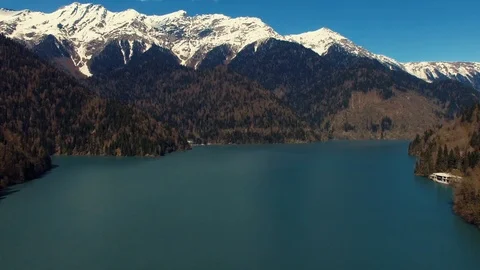 A natural landscape, a view of the snow-capped mountains, a blue lake and trees Stock Footage 89901753